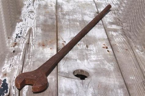 A heavy iron lever with one pointed end and the other forged.